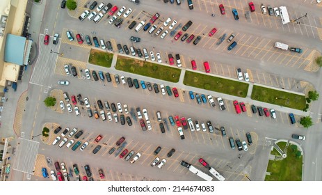 Aerial View Of Cars At Large Outdoor Parking Lots, USA. Outlet Mall Parking Congestion And Crowded Parking Lot, Other Cars Try Getting In And Out, Finding Parking Space.