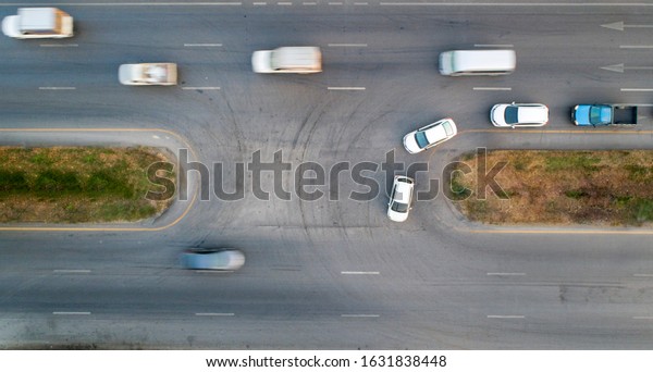 Aerial view of cars making\
a U-turn. 