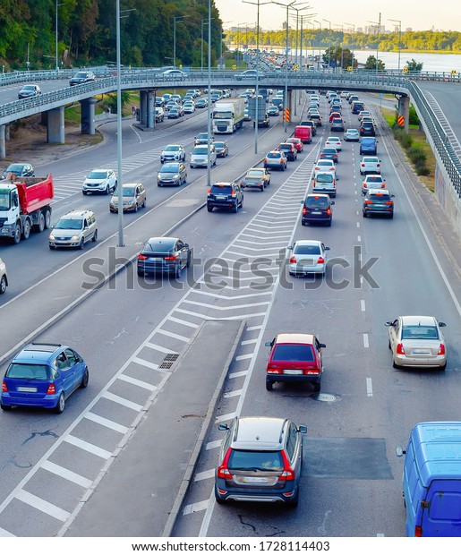 Aerial view of cars\
at traffic instersection by the Dnipro river embankment, rush hour,\
Kyiv, Ukraine