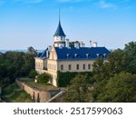 Aerial view of Raduň Castle Hidden Among Lush Greenery with Iconic Spire – Serene Landscape, blue sky, summer time. Ideal for Travel and Architectural Content. Moravia, Czech republic.