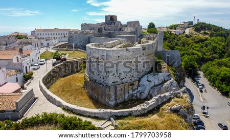Aerial view of the castle of Monte Sant'Angelo on the Gargano peninsula in Italy, photographed from a drone in flight - Medieval stronghold on a hilltop over the Adriatic Sea