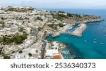 Aerial view of Castro and the city marina in the province of Lecce, Salento, Puglia, Italy. The historic center of the town is located on a promontory while the port overlooks the Adriatic sea.