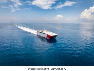 Aerial View Of A Catamaran Jet Passenger Ferry Traveling With Speed Over Blue Ocean