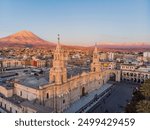 
aerial view of the cathedral of Arequipa with the background of the Misti volcano and Pichu Pichu at sunset