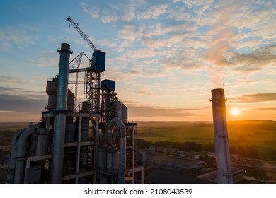 Aerial view of cement factory with high concrete plant structure and tower crane at industrial production area. Manufacture and global industry concept. - Shutterstock ID 2108043539