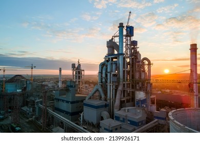 Aerial view of cement factory with high concrete plant structure and tower crane at industrial production area. Manufacture and global industry concept. - Shutterstock ID 2139926171