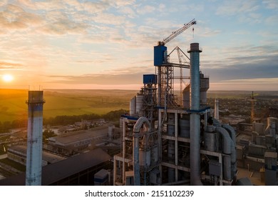 Aerial view of cement factory with high concrete plant structure and tower crane at industrial production area. Manufacture and global industry concept. - Shutterstock ID 2151102239