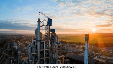 Aerial view of cement factory with high concrete plant structure and tower crane at industrial production area. Manufacture and global industry concept. - Shutterstock ID 2308210257