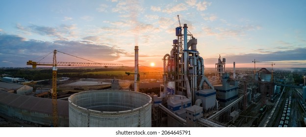 Aerial view of cement factory tower with high concrete plant structure at industrial production area. Manufacturing and global industry concept. - Shutterstock ID 2064645791