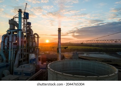 Aerial view of cement factory under construction with high concrete plant structure and tower cranes at industrial production area. Manufacture and global industry concept. - Shutterstock ID 2044765304
