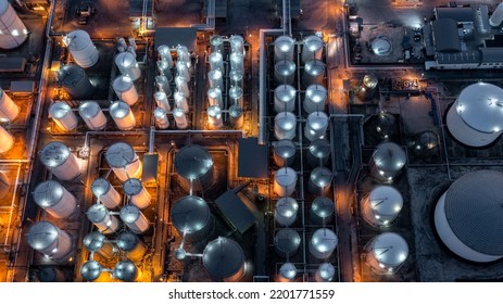 Aerial view chemical storage tank on sea at oil terminal station at night, Chemical plant petroleum and petorchemical product, Chemical industry plant in refinery at night,