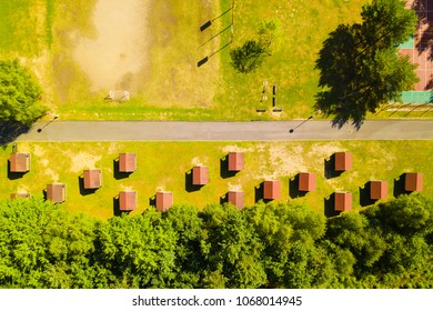 Aerial View Of Children Summer Camp Site And Recreational Area Near Forest. Drone View Of Many Holiday Cottages. Background Texture Concept.