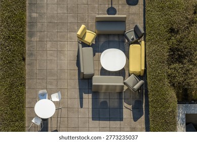 aerial view of chirs, tables and sofas on a terrace in Berlin in afternoon sunlight