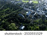 Aerial view of the Christchurch Botanic Gardens in Christchurch, New Zealand, showcasing lush greenery and urban surroundings.