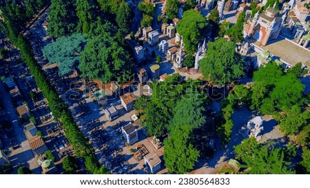 Aerial view of the Cimitero Monumentale cemetery. The cemetery is famous for tombstones in various styles, as well as the graves of famous artists and architects. Skyline with skyscrapers. Milan Italy