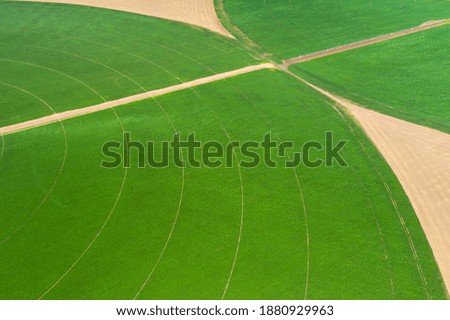 Similar – Aerial view of lush green rice field with small winding canal. Sustainable agriculture landscape. Sustainable rice farming. Rice cultivation. Green landscape. Organic farming. Sustainable land use.