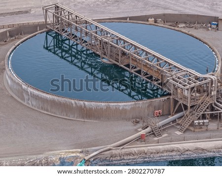 Aerial view of circular mining thickener with metal frame and rotating bridge