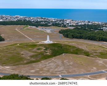 Aerial View Of Circular Road Loop Surrounding Hilltop Wright Brothers Monument With Outer Banks Coastline In Distance