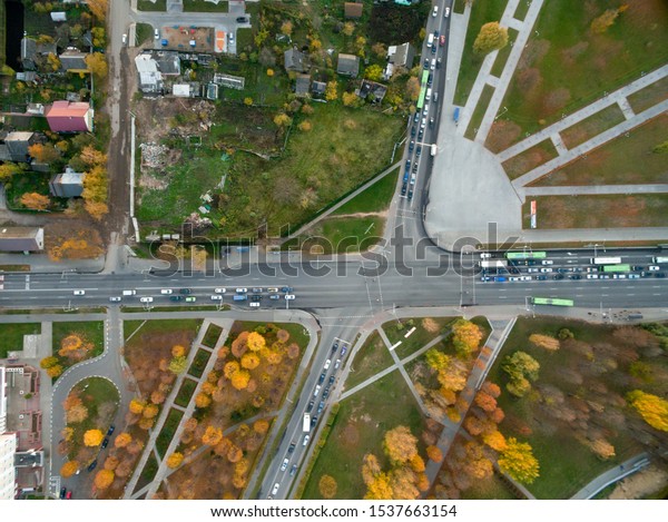 Aerial view to\
the city crossroads with a car and traffic lights. Urban transport\
concept aerial view. Top\
view