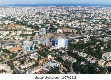 Aerial View Of The City Of Dakar, Senegal, Showing The Densely Packed Buildings And A Highway