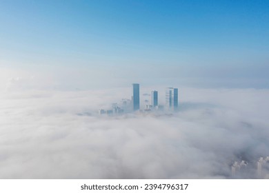 Aerial view of the city in the fog. Skyscrapers above the fog