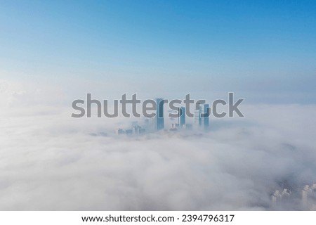 Aerial view of the city in the fog. Skyscrapers above the fog