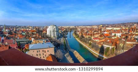 Aerial view from the city hall tower over Oradea town with new and historic buildings. Crisul Repede, the local river, in front.