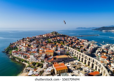 Aerial view the city of Kavala in northern Greek, ancient aqueduct Kamares, homes and medieval city wall 