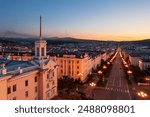 Aerial view of the city of Magadan. Top view of the streets and buildings. Morning cityscape. Building with a tower in the historical center of the city of Magadan. Magadan region, Far East of Russia.