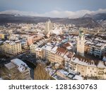 Aerial view city tower and wooden bridge in Olten, Jura mountains, Aare,  townhouse, St. Martin Church during Winter with snow on rooftops