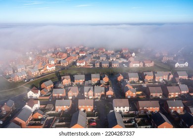 Aerial View Of City Under The Fog In England - New Estate With Typical British Houses And Green Gardens Hidden By Clouds - Nature And Buildings Concepts In UK