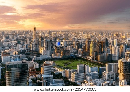 Aerial view of cityscape of Bangkok city, Thailand from roof top bar with sunset sky in lumpini area