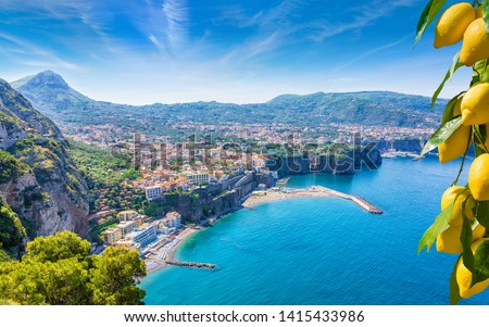 Aerial view of cliff coastline Sorrento and Gulf of Naples, Italy. Ripe yellow lemons in foreground. In Sorrento lemons are used in production of limoncello.