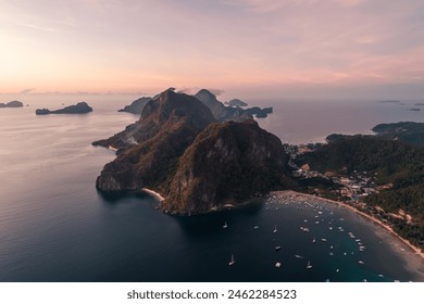 Aerial view of cliffs in the sea, yachts are sailing nearby, mountains covered with tropical forest. El Nido, Palawan, Philippines. - Powered by Shutterstock