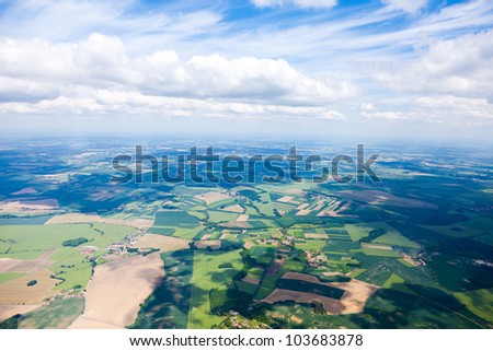 aerial view of clouds and village landscape
