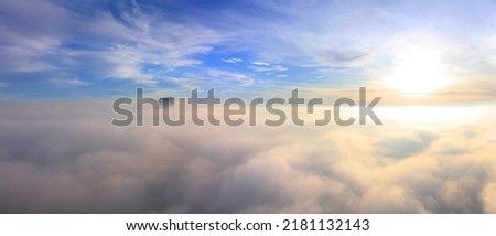 Aerial view Cloudy sunrise  sky. Beautiful Aerial Clouds landscape Misty foggy sky clouds HRD images. Cloudscape Scenic view  from  airplane. Skyscraper panorama  clouds sky heaven horizontal lines