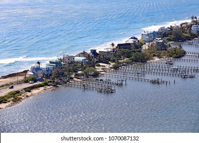 Aerial view of a cluster of homes on Hutchinson Island, Florida, with boat docks into the shallow lagoon.  Prime real estate.
