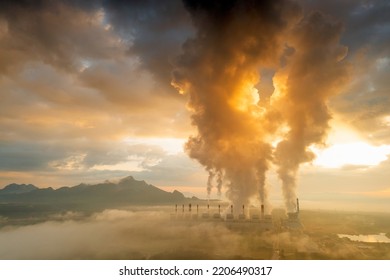 Aerial view coal power plant station in the morning mist, the morning sun rises. coal power plant and environment concept. Coal and steam. Mae Moh, Lampang, Thailand. - Shutterstock ID 2206490317
