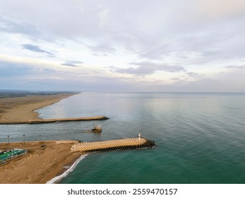 Aerial view of a coastal harbor with breakwaters and a small boat.High-angle, full shot of a coastal harbor. Sakarya Adapazari Turkiye Turkey Karasu Drone shot nice sunrise  beautiful  - Powered by Shutterstock