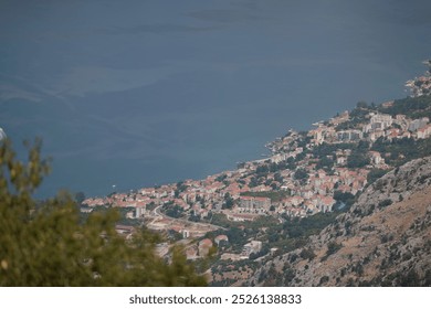 Aerial view of a coastal town on a mountainous landscape by the sea in tranquil daylight - Powered by Shutterstock