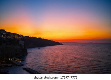 Aerial view of coastline Sorrento city and Gulf of Naples with colorful sunset sky