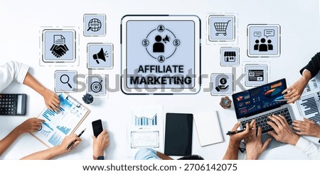 Aerial view of a collaborative workspace focused on affiliate marketing strategies, featuring digital tools, charts, and team engagement around marketing concepts. Trope