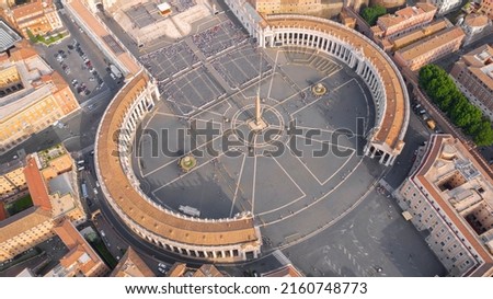 Aerial view of the colonnade and St. Peter's square located in the Vatican city. This state is an enclave within the city of Rome, Italy. The obelisk in the center is known as 