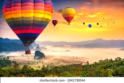 Aerial view from colorful hot air balloons flying over with the mist at Phu Langka national park in sunrise time,  Phayao province in Thailand. - Shutterstock ID 1041738544