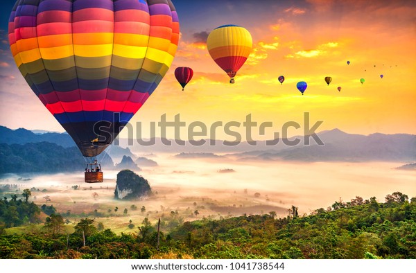 Aerial view from colorful hot air balloons flying over with the mist at Phu Langka national park in sunrise time, Phayao province in Thailand.