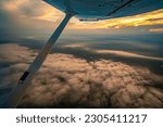 Aerial view of colorful sky at sunset as seen from a single engine plane,