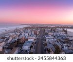Aerial view of colorful sunrise sky over Mission Beach San Diego with residential vacation homes, villas with nobody on the street