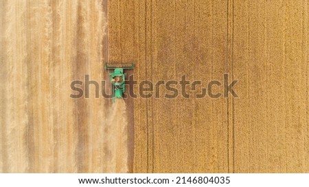 Aerial view combine harvester harvesting on the field