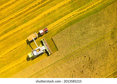 Aerial View Of Combine Harvester On Wheat Field. Agriculture And Carbon Footprint Theme.