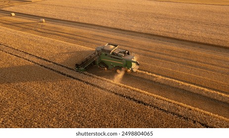 aerial view of combine harvester at work. summer field work on the farm - Powered by Shutterstock